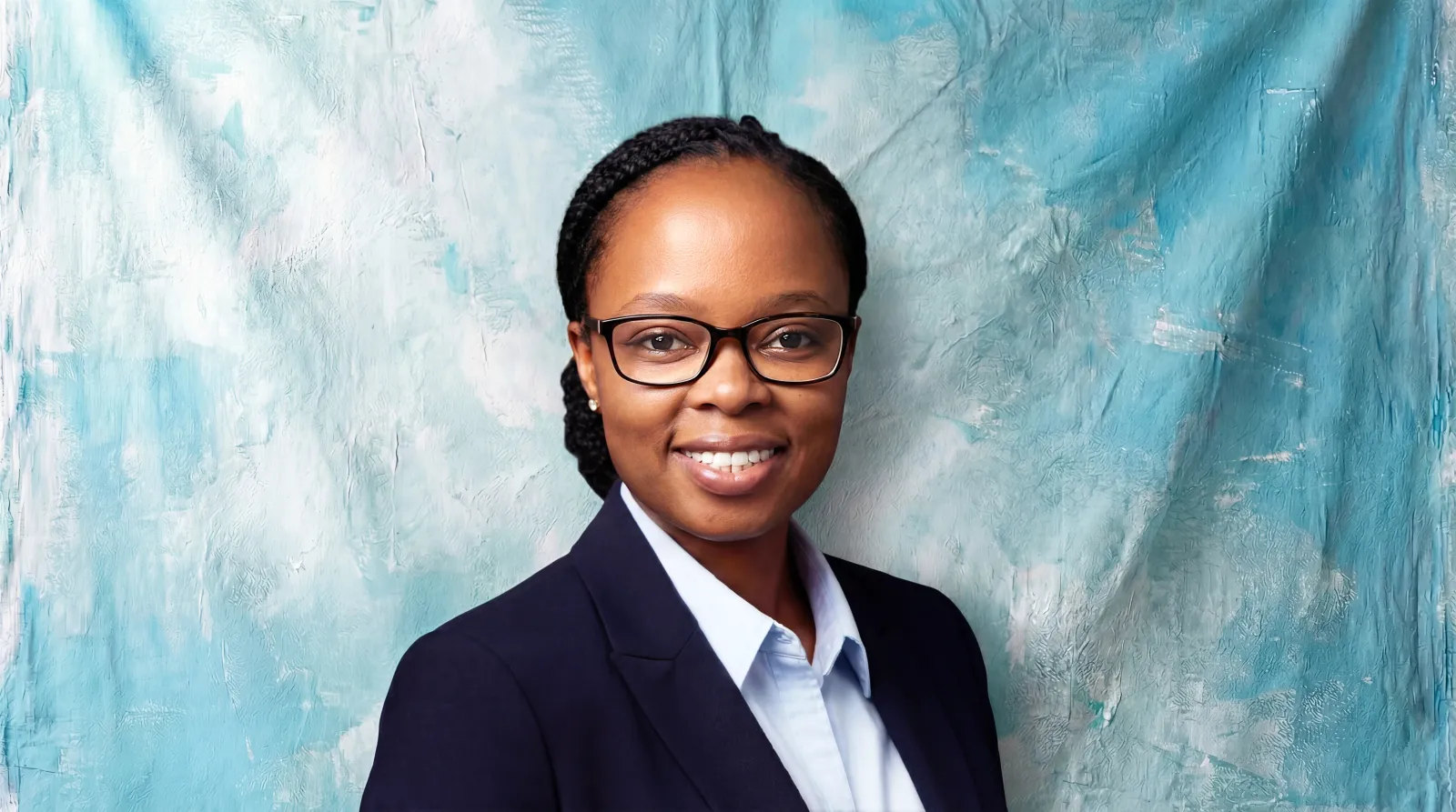 Primrose Moruti, Business Development Partner at Blu Frame, smiling in glasses against an artistic turquoise backdrop